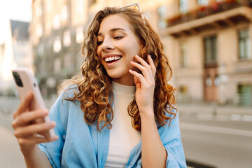 Beautiful woman using mobile in the Street. Youth concept.  Business, technology, blogging,...