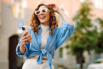 Beautiful woman using mobile in the Street. Youth concept.  Business, technology, blogging,...