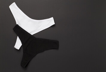 Women's cotton panties on color background, top view