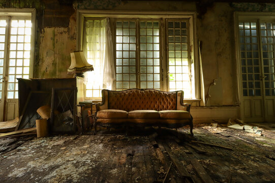 old abandoned house with an vintage sofa and an old lamp