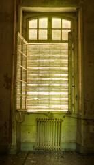 open window with an old rusty radiator