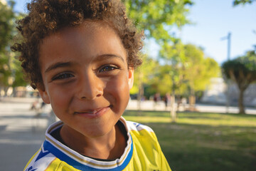 Portrait of a smiling boy. African American boy. Playing in the park with a soccer jersey. Afro...