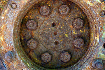 Rust hub of the old wheel, texture.Corrosive grunge rusted on old iron wheel. Pattern grunged rust as illustration for presentation background. Rusty corrosion or oxidized background.Close up.