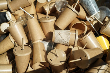 Eco-friendly disposable brown paper cups and plastic glasses used from coffee cafe, restaurants,...