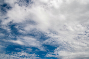 The sky is blue and cloudy. The clouds are white and fluffy