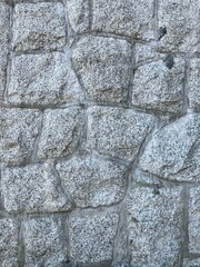 Natural stone wall seamless texture background, stonewall closeup
