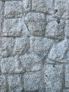 Natural stone wall seamless texture background, stonewall closeup
