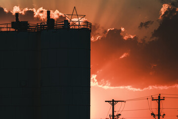 sunset behind an industrial building