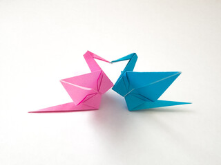 Two origami crane bird making heart shape