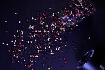 Peppercorns on a black background scattered on the surface