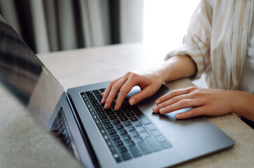 Close-up of a woman typing on a laptop keyboard. Business, Freelance, Shopping, education. Online.