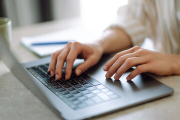 Close-up of a woman typing on a laptop keyboard. Business, Freelance, Shopping, education. Online.