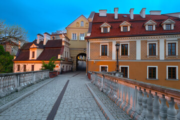 Fototapeta na wymiar 2023-05-07; evening cobbled street leading to the city gate and old center of historic Lublin poland