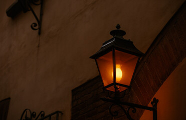 Evening vintage old style street lamp on the street lighted.