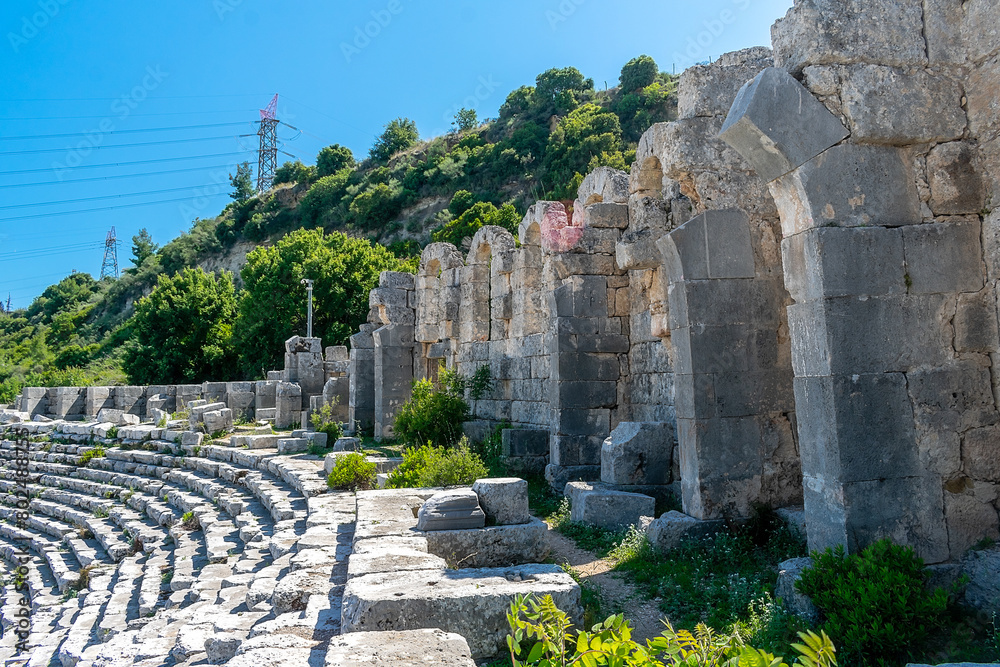 Wall mural Picturesque ruins of an amphitheater in the ancient city of Perge, Turkey. Perge open-air museum.