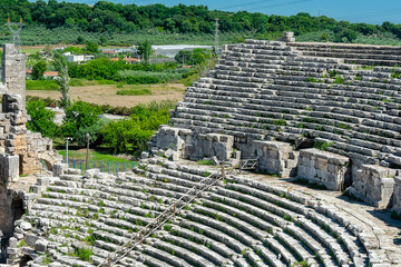 Picturesque ruins of an amphitheater in the ancient city of Perge, Turkey. Perge open-air museum.