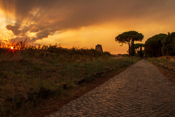 sunset on ancient roman road of appian way