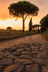 sunset on ancient roman road of appian way