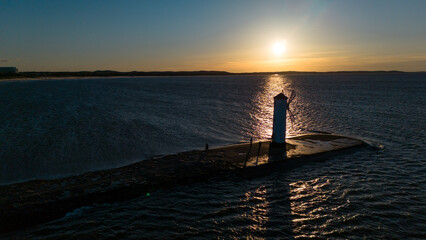 lighthouse mill in swinoujscie in poland in spring at sunset