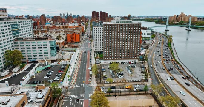 Flight over the waterfront of the Harlem River in New York. Wards Island Bridge at backdrop. Top view.