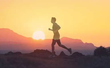 Man running in nature at sunset, physical health, fitness concept. 