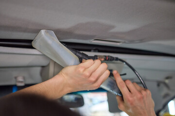 Carwash service, cleaning of car ceiling covering