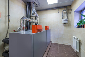 Modern gas boiler room with equipment for an autonomous heating system.