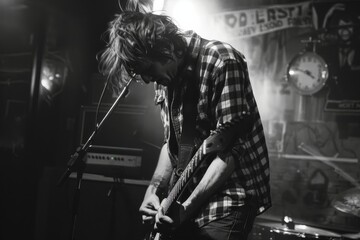 A focused guitarist is immersed in music, playing passionately in a black and white, gritty club atmosphere