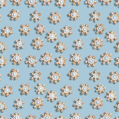 Seamless pattern of ginger bread in snowflake shapes on modern light blue backgrounds,  christmas background pattern cookies with christmas endless infinity pattern.