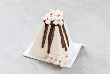 Cottage cheese Easter with chocolate. Decorated with white marshmallow flowers. Close-up