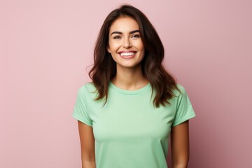 A woman with a green shirt is smiling and looking at the camera