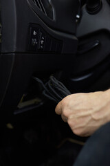 Individual is performing maintenance on the vehicles dashboard