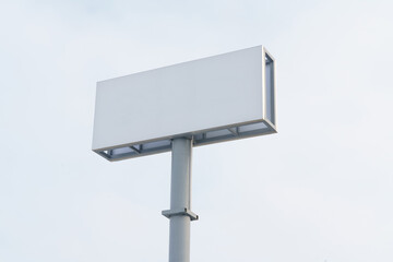 Large White Sign on Metal Pole