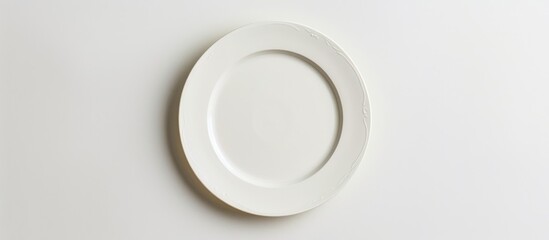 An empty plate pictured against a white background. Seen from a top-down perspective.