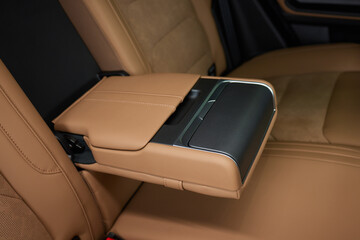 Luxury car back seat with open arm rest in sleek hardwood design