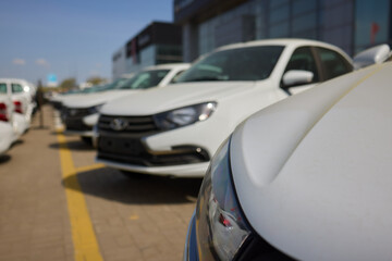 Car Sales and Loan Industry Concept. Row of Brand New Vehicles in Stock.