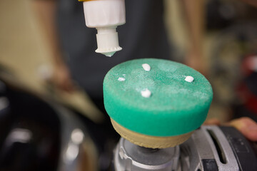 An electric blue sponge ornament is being polished by a machine