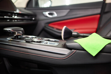 Vehicle dashboard includes a green cloth and a brush