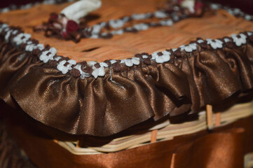 tissue box made of rattan and decorated with brown ribbon