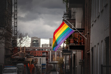 Selective blur on a Rainbow gay flag hanging in Le Village, the gay district of the city center of...