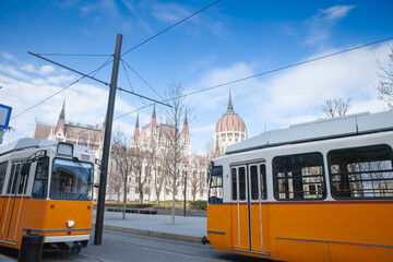 Selective blur on Budapest trams, called Villamos, on a tram stop in front of the hungarian parliament in Budapest. It is the main public transportation network of the hungarian capital city.