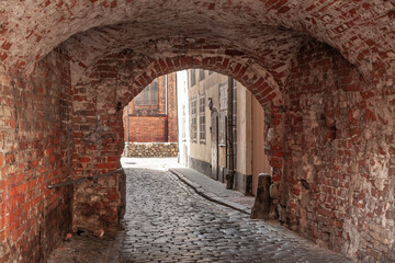 Panorama of a narrow street in Riga, a pedestrian cobblestone street of Vecriga Vecpilseta, the historical center old town of Latvian capital city.