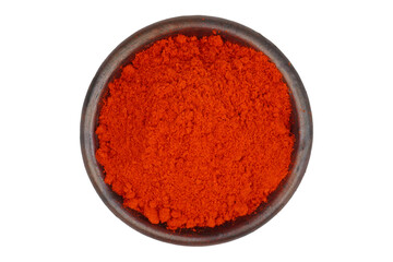 Cayenne pepper powder in a clay bowl isolated transparent