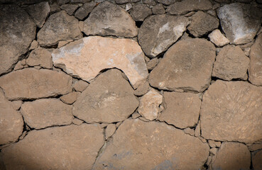 grey stone dark wall of medieval horizontal stones facade background 2
