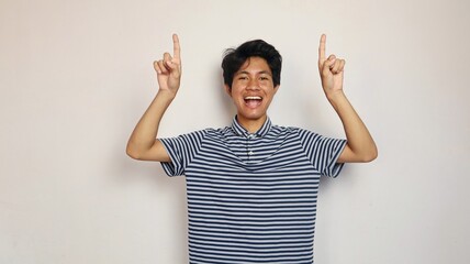Handsome Asian man pointing upwards