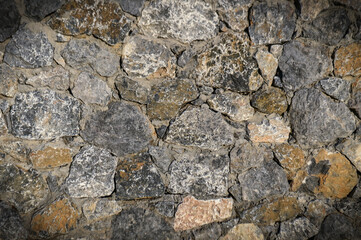 grey stone dark wall of medieval horizontal stones facade background