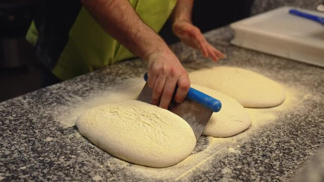 chef ready to prepare dough to make pizza in the bakery, vertical shot. High quality 4k footage