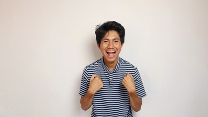 young asian man shows an enthusiastic pose