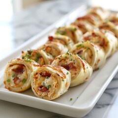 Chicken Bacon Ranch Roll-Ups showing the golden-brown, melted mozzarella cheese encasing the mixture of shredded chicken, crispy bacon pieces, and flecks of green onion