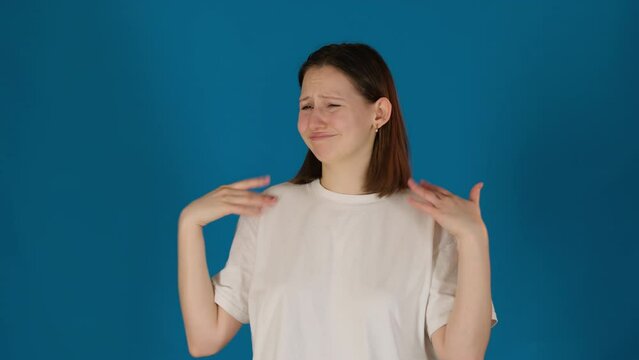Lady searches way to escape unpleasant smell on blue background. Woman hopes to find relief from noxious odor eager to restore sense of comfort slow motion